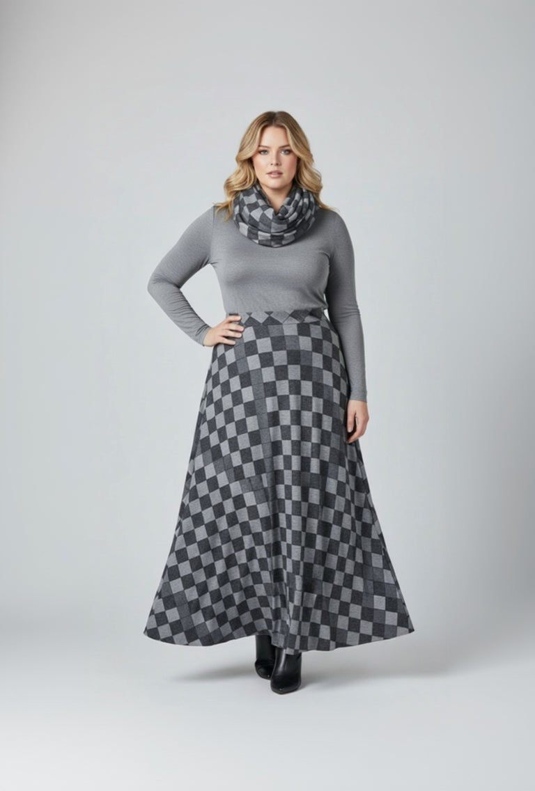 Woman wearing a gray sweater and checkered skirt on a white background