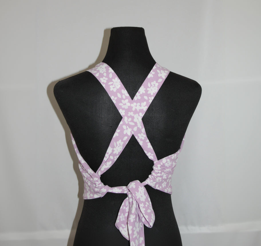 Purple floral-patterned top on a black mannequin against a white background