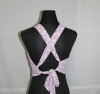 Purple floral-patterned top on a black mannequin against a white background