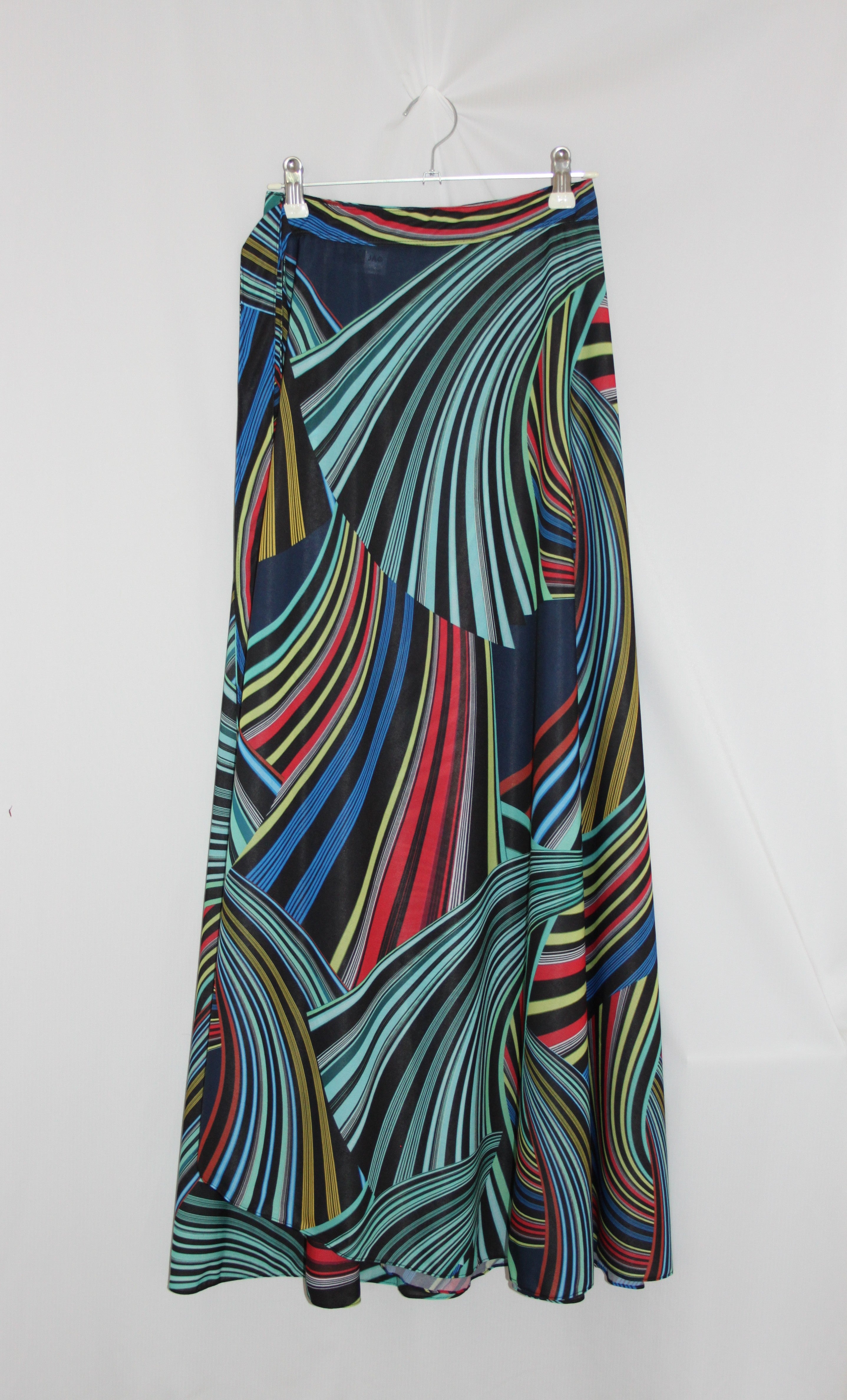 Colorful patterned skirt on a hanger against a white background