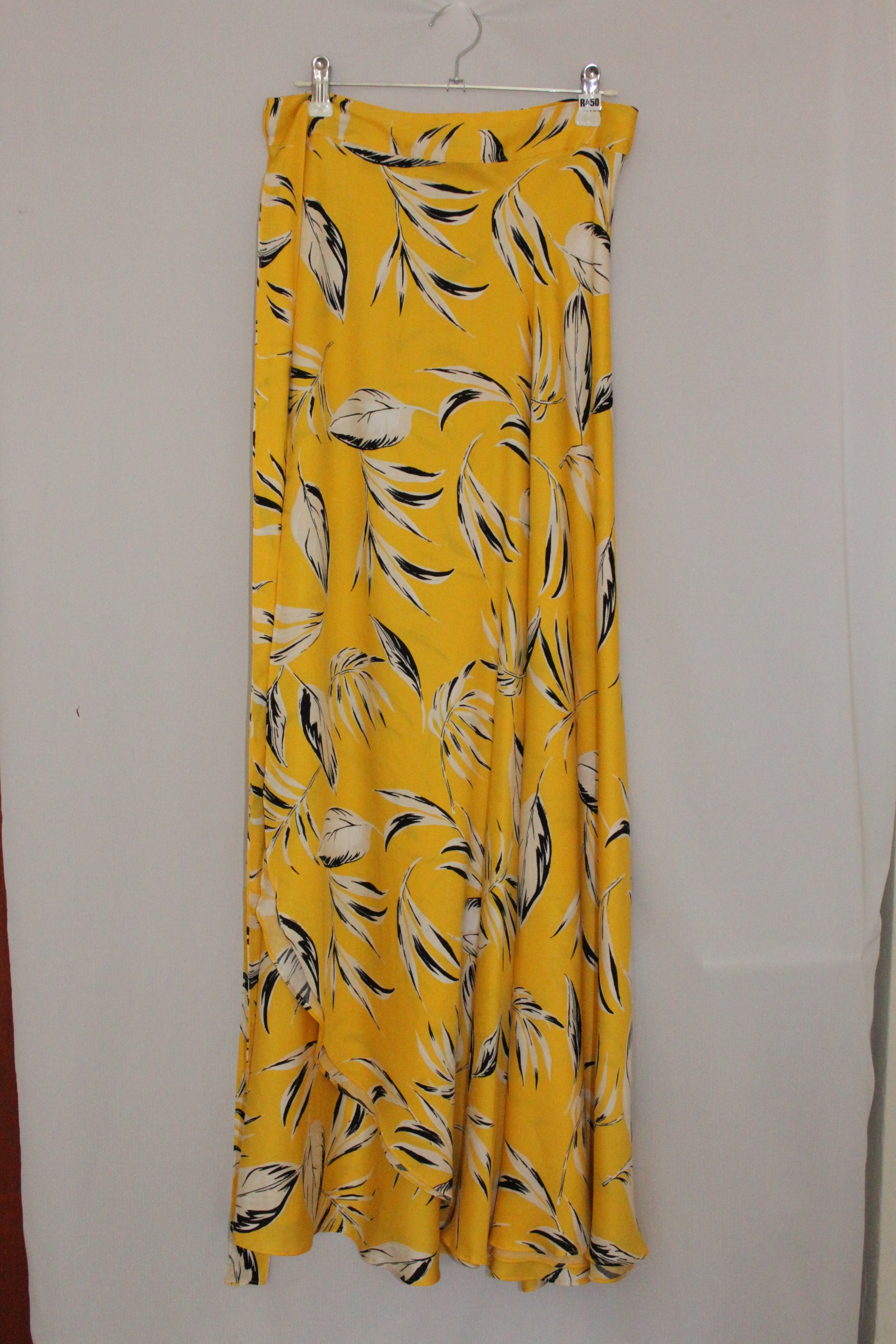 Yellow fabric with black and white leaf pattern on a white background