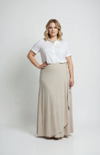 Woman wearing a white blouse and beige skirt on a white background