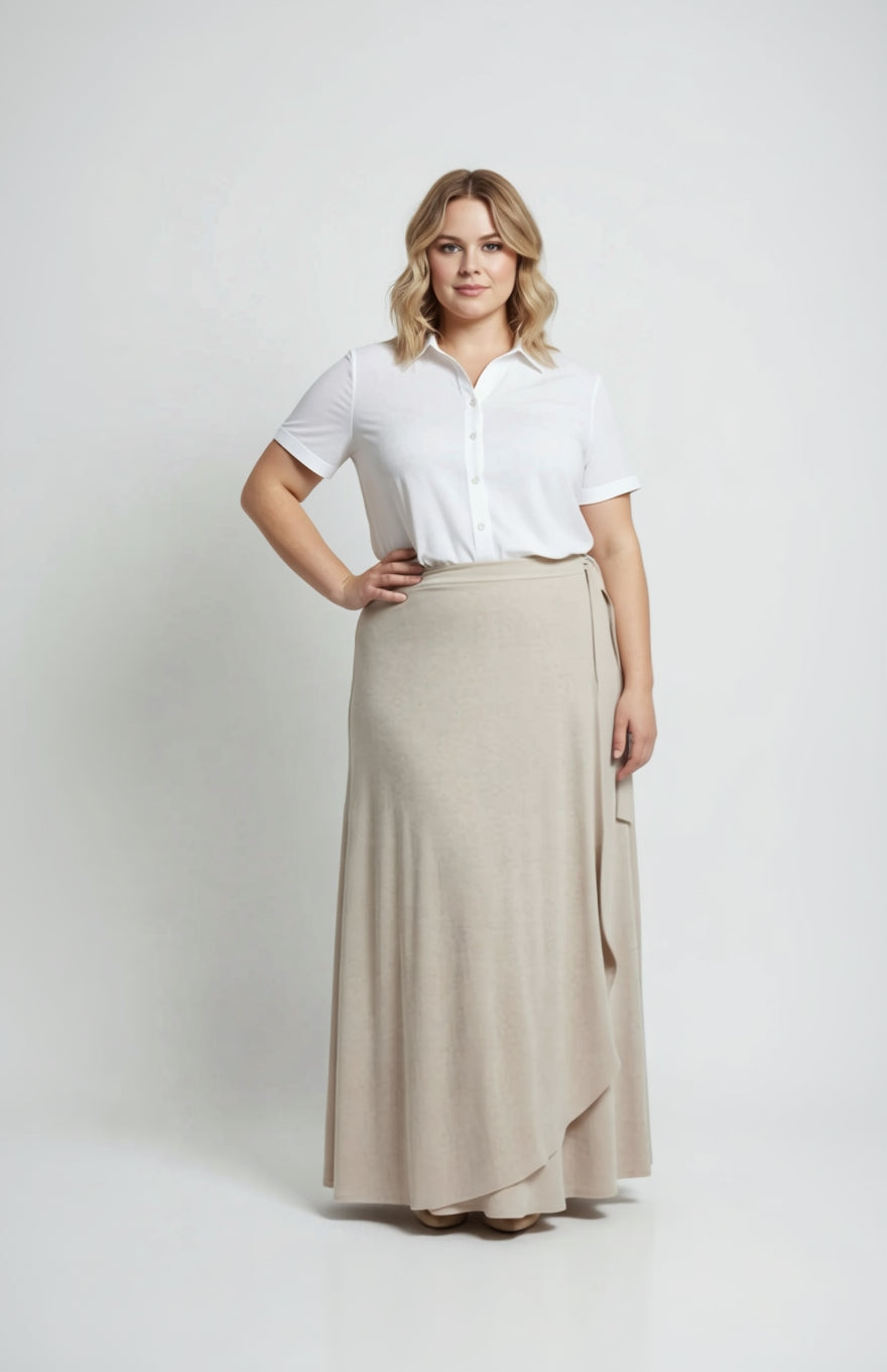 Woman wearing a white blouse and beige skirt on a white background