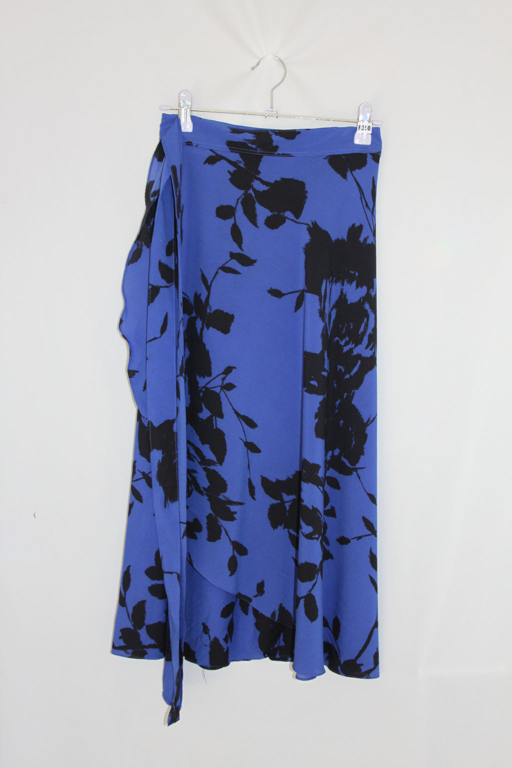 Blue fabric with black floral pattern on a white background