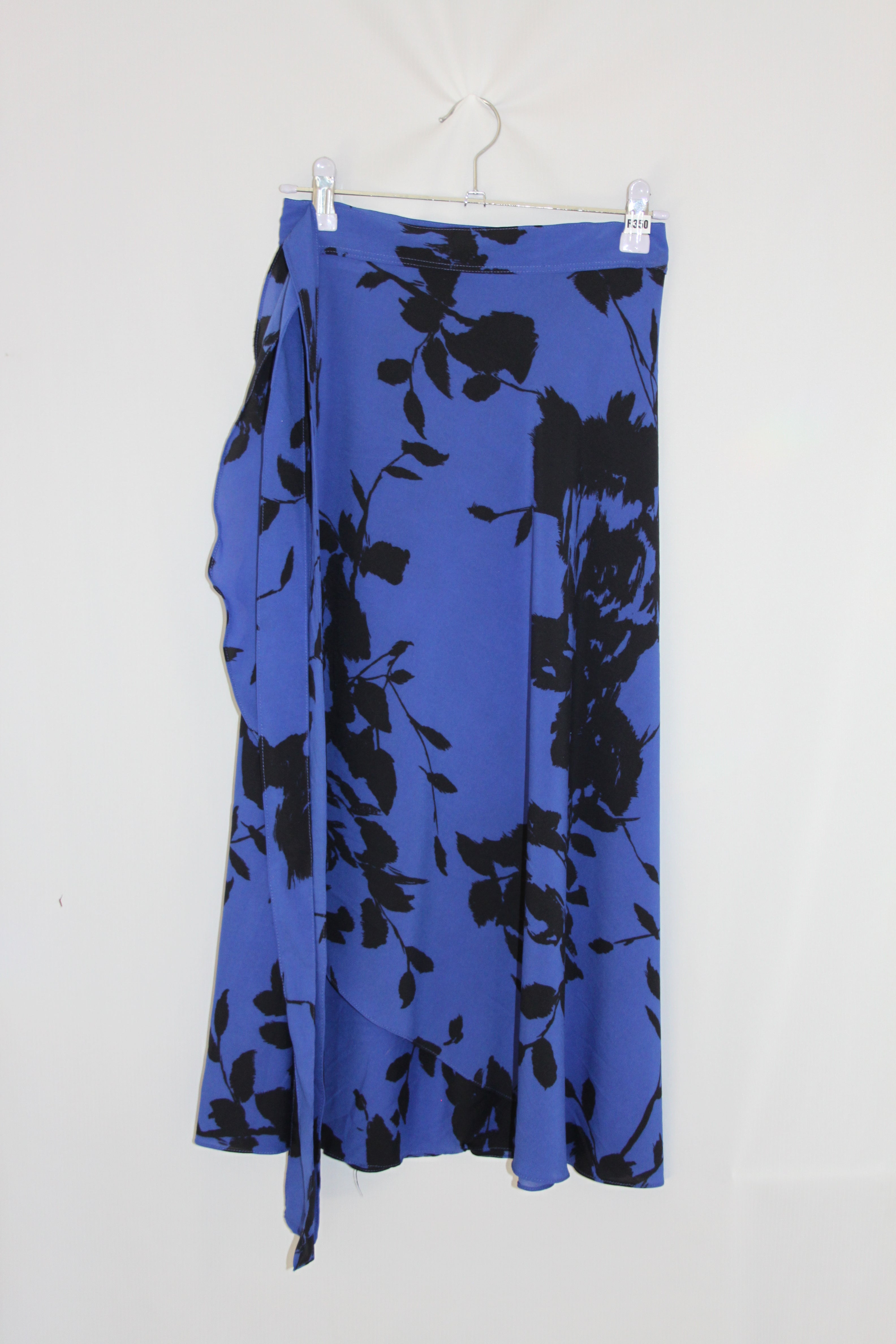 Blue fabric with black floral pattern on a white background