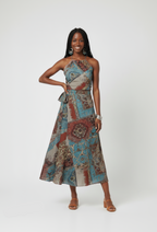 Woman wearing a patterned dress on a plain background