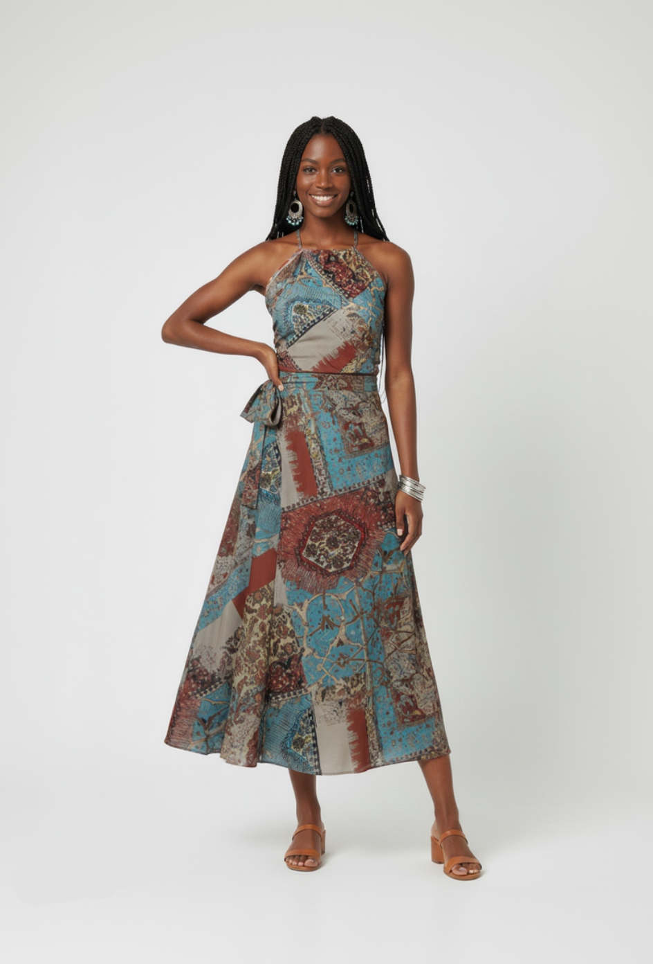 Woman wearing a patterned dress on a plain background