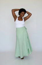 woman wearing a green polka dot skirt on a white background