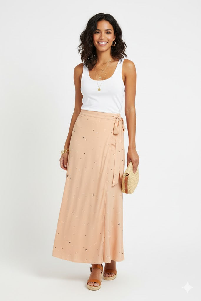 Woman wearing a white tank top and peach skirt with a white background