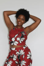Woman wearing a red floral outfit against a white background