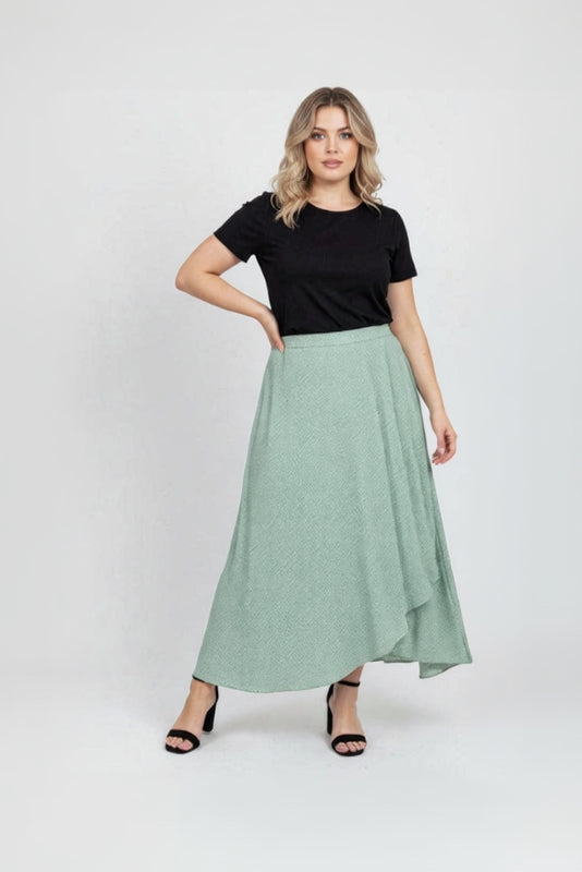 Woman wearing a black t-shirt and green skirt on a white background